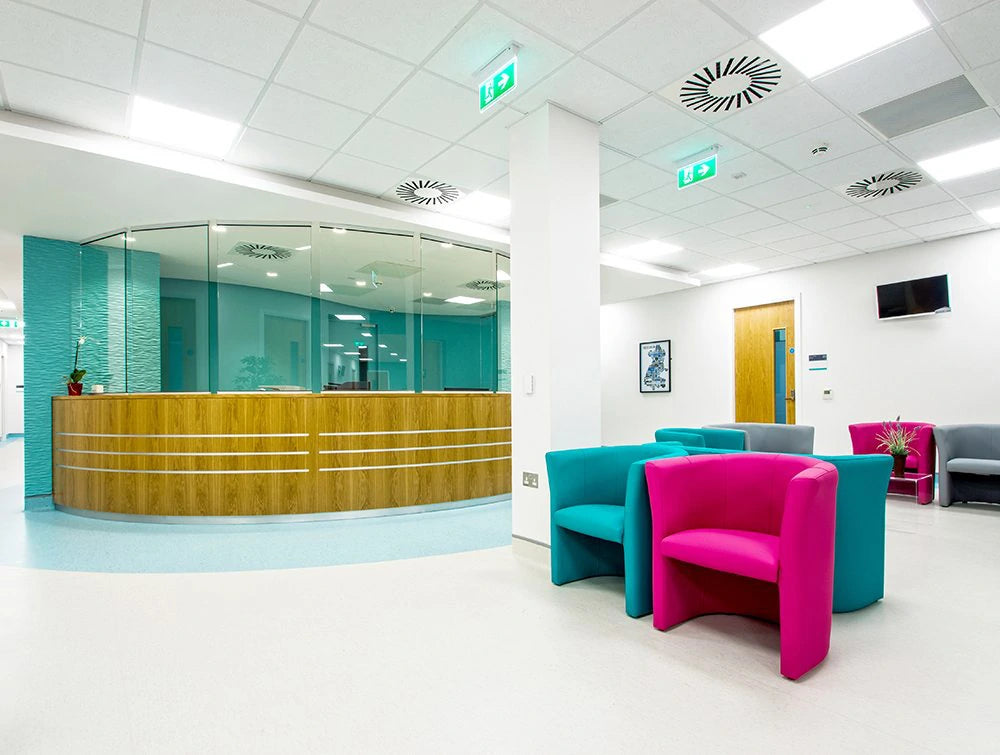 Reception Area Of Hospital Building With Bright Chairs