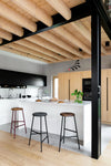 Rotor Upholstered and Wooden Bar Stools with White Counter Top in Modern Kitchen Setting