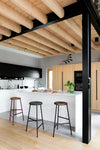 Rotor Upholstered and Wooden Bar Stools with White Counter Top in Modern Kitchen Setting