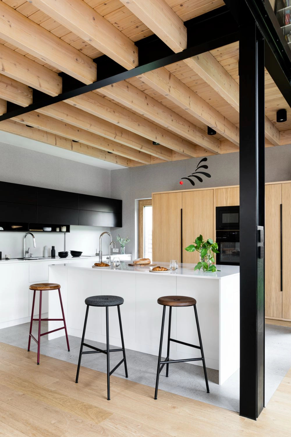 Rotor Upholstered and Wooden Bar Stools with White Counter Top in Modern Kitchen Setting