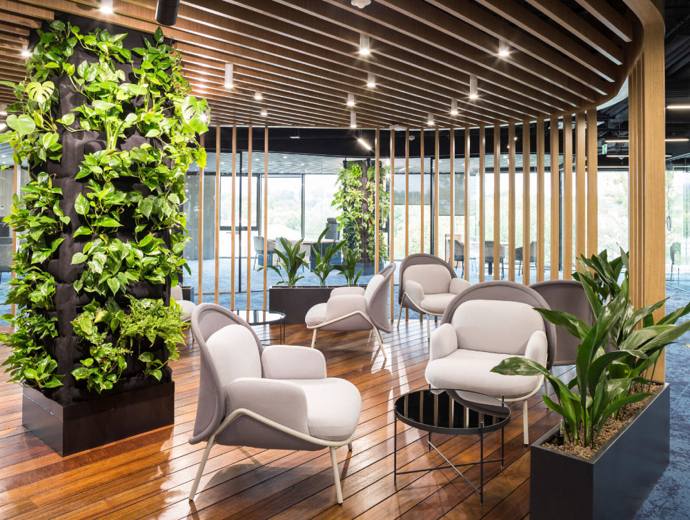 Round Coffee Table Office Furniture With Lounge Chair And Indoor Plant In Breakout Setting