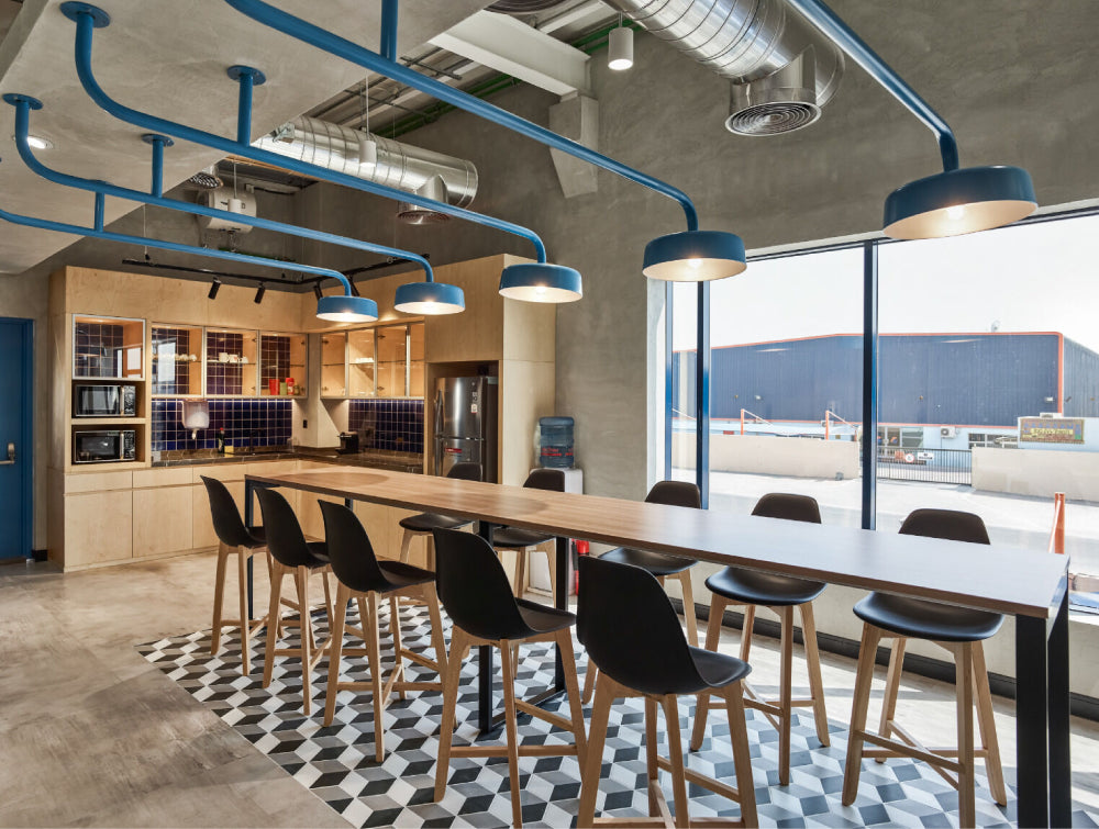 Upholstered High Stool Office Furniture With Wooden Long Table And Shelves In Breakout Setting