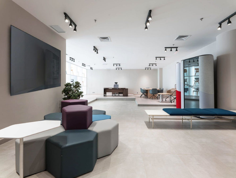 Upholstered Pouffe Office Furniture With White Coffee Table And Indoor Plant In Executive Office Setting