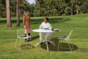 Urbantime Eclipse Outdoor Wire Chair In White Finish With Round Table In Forest Park Setting