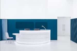 Valde Modular Reception Desk with with Visitor Chair and Table Lamp in Reception Setting