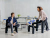 Varier Ekstrem Multiposition Chair 11 In Black With Long Black Table In Modern Office Setting