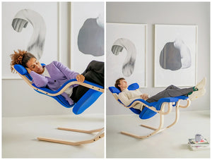 Varier Gravity Balans Zero Gravity Chair 12 In Blue With Stacks Of Books In Resting Area