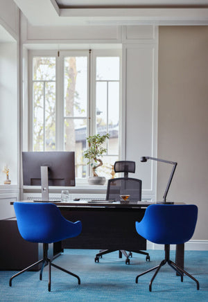 Viga Executive Desk With Tub Chair And Flower Vase In Office Setting