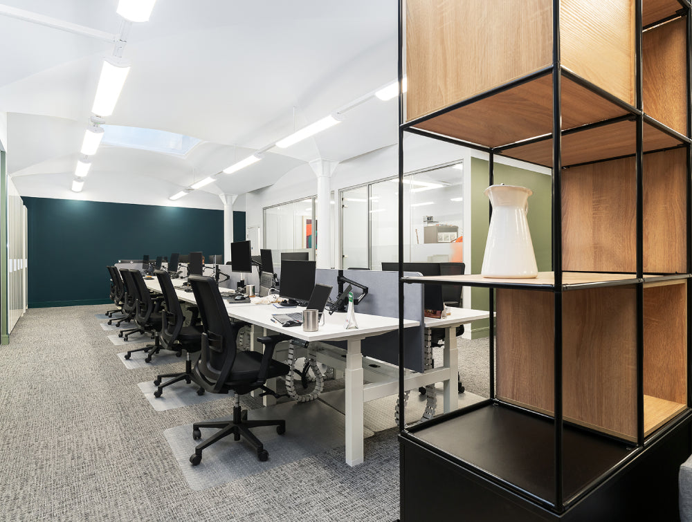 White Bench Desk With Ergonomic Chair And Shelves In Office Setting