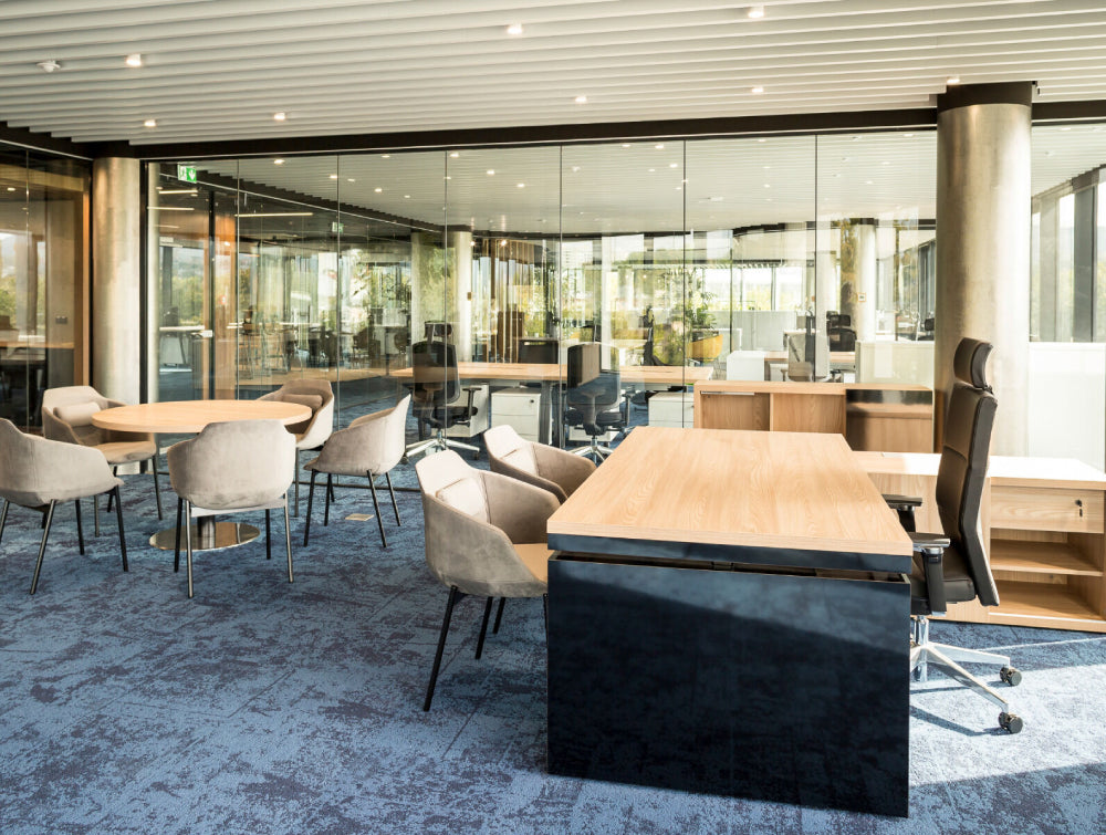 Wooden Executive Desk Office Furniture In Two Toned Finish With Ergonomic Chair And Round Table In Executive Office Setting