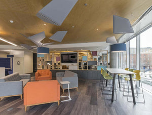 Wooden Partitions Grid Between Office Space And Communal Space With Sofas High Stool Table And Acoustic Ceiling Panel