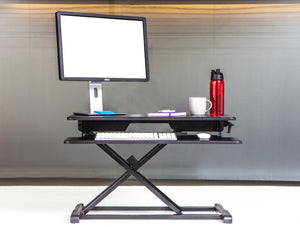 Yo Yo Desk 80 S Sit Stand Solution Black 4 With Red Tumbler And Computer Monitor And Keyboard On Top