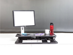 Yo Yo Desk 80 S Sit Stand Solution Black 5 With Red Tumbler And Computer Monitor And Keyboard On Top