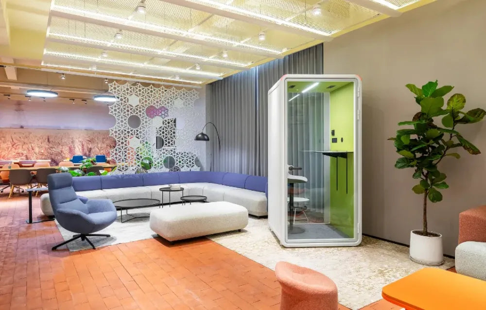 Zum Phonebooth in White Finish with Lounge Chairs and Indoor Plant in Reception Setting